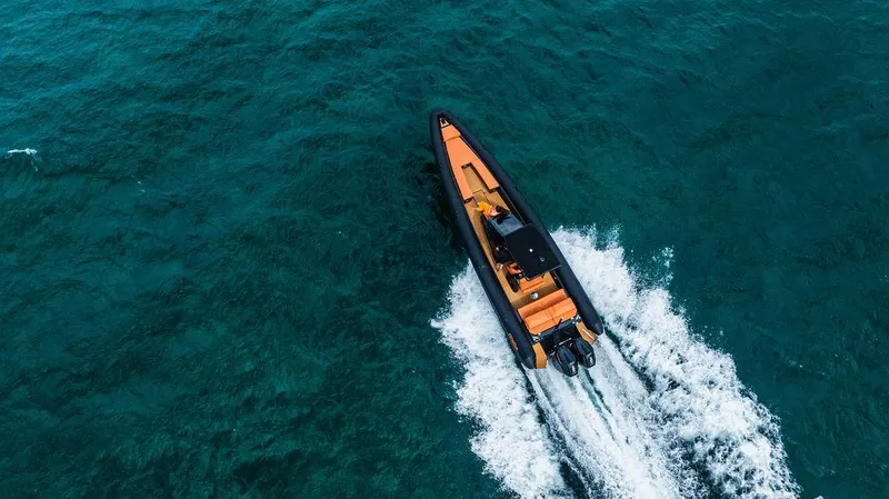 Slide: The Image of Aerial view of 2025 Onda Magna boat cruising on clear blue water. - 2