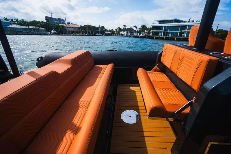 Slide: The Image of Luxurious 2025 Onda Magna boat interior with orange seating and waterfront view. - 7