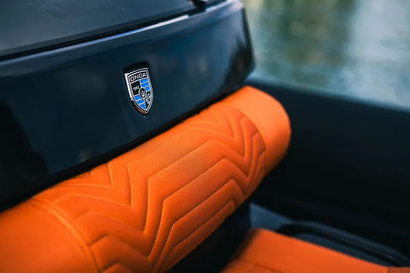 Slide: The Image of 2025 Onda Magna interior with orange upholstery and logo detail. - 9