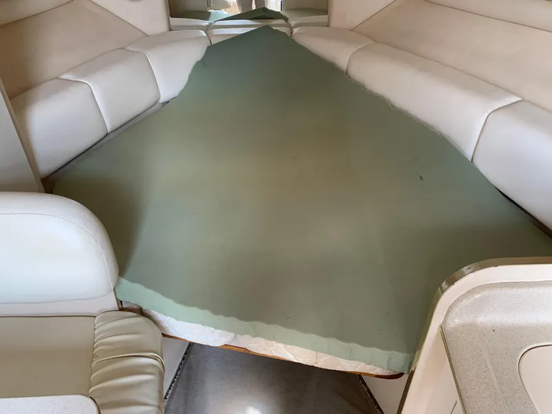 Slide: The Image of Interior cabin of 2000 Sea Ray 270 Sundancer with cushioned seating. - 11