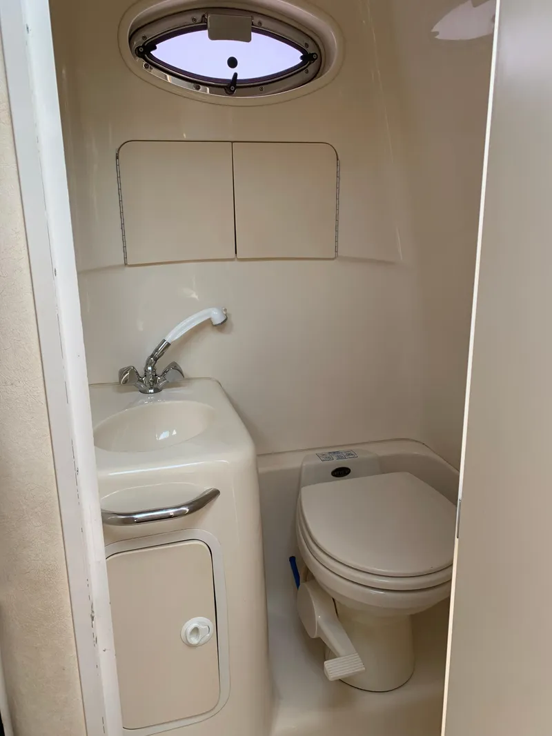 Slide: The Image of Compact bathroom in 2000 Sea Ray 270 Sundancer boat with sink and toilet. - 13