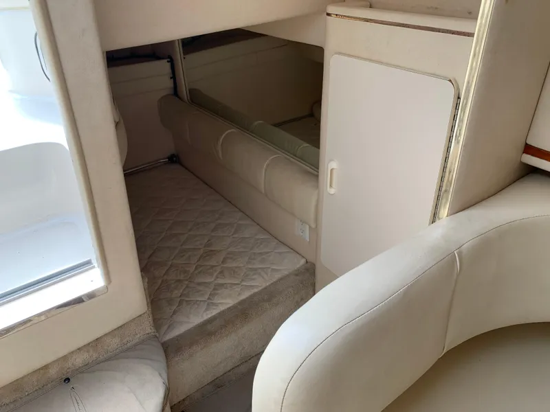 Slide: The Image of Interior cabin of 2000 Sea Ray 270 Sundancer with beige upholstery and compact design. - 15