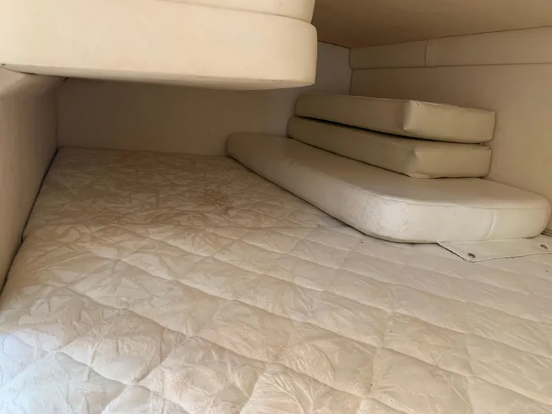 Slide: The Image of Interior cabin of 2000 Sea Ray 270 Sundancer with white cushions and mattress. - 16