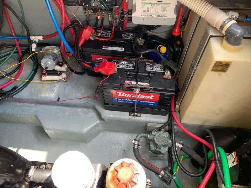 Slide: The Image of Engine compartment of 2000 Sea Ray 270 Sundancer with Duralast marine batteries and wiring. - 18