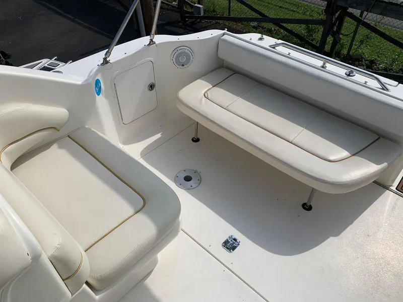 Slide: The Image of Interior seating of 2000 Sea Ray 270 Sundancer boat, featuring white cushioned seats. - 4