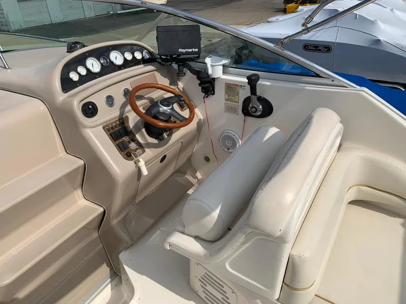 Slide: The Image of 2000 Sea Ray 270 Sundancer helm with steering wheel, gauges, and Raymarine navigation system. - 6