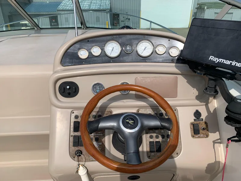 Slide: The Image of Dashboard of a 2000 Sea Ray 270 Sundancer boat with steering wheel and gauges. - 7