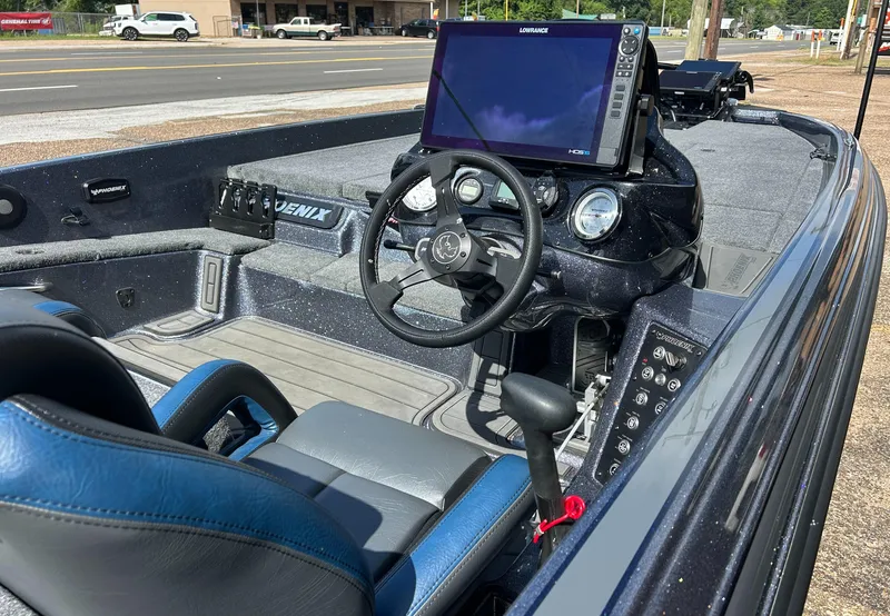 Slide: The Image of 2024 Phoenix 21 XE boat interior with steering wheel and navigation system. - 4