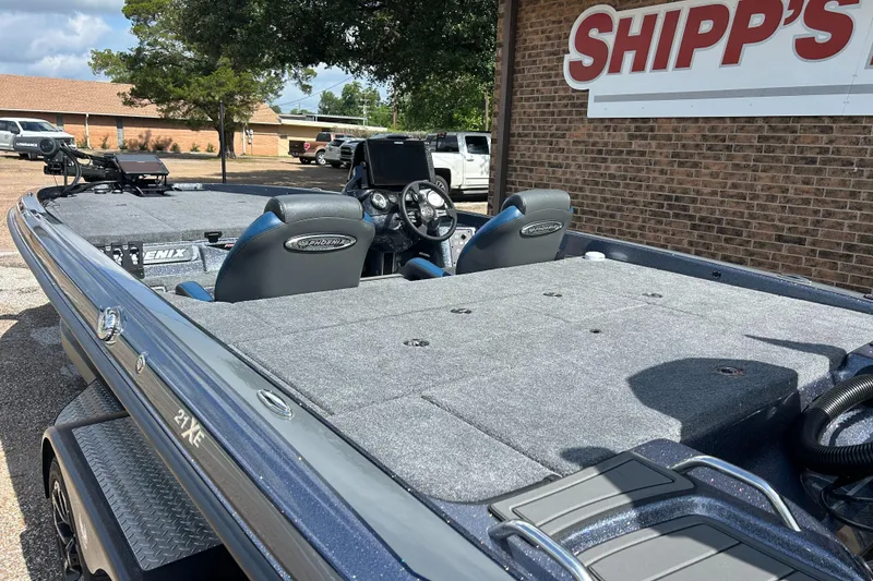 Slide: The Image of 2024 Phoenix 21 XE boat with dual seats, parked outside Shipp's store. - 5