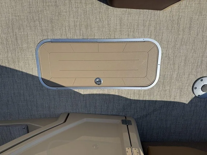 Slide: The Image of Hatch on 2025 Godfrey Monaco 235 SFL iMPACT boat, beige textured surface. - 16