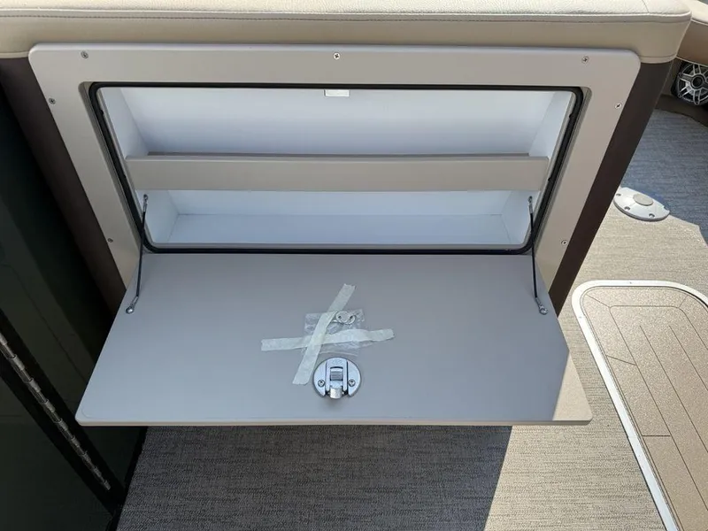 Slide: The Image of Open storage compartment on 2025 Godfrey Monaco 235 SFL iMPACT boat. - 22