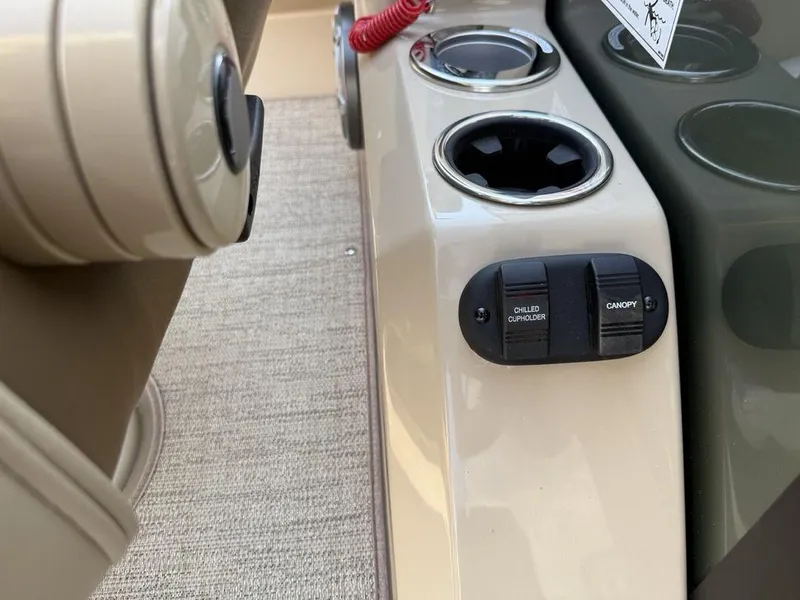 Slide: The Image of 2025 Godfrey Monaco 235 SFL boat console with chilled cupholder and canopy controls. - 31