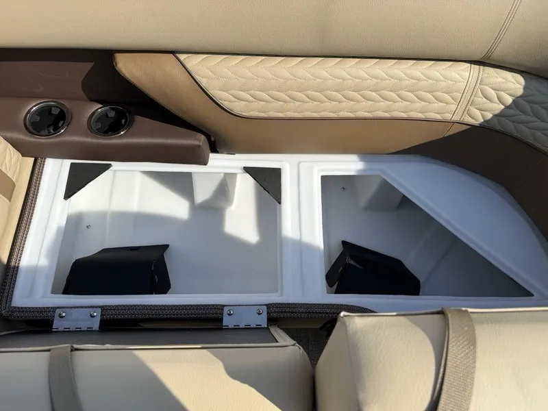 Slide: The Image of Interior storage compartment of 2025 Godfrey Monaco 235 SFL iMPACT boat, featuring beige upholstery. - 5
