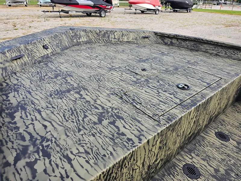 Slide: The Image of 2026 Tracker Grizzly 1860 CC boat with camouflage pattern, parked on a trailer. - 14