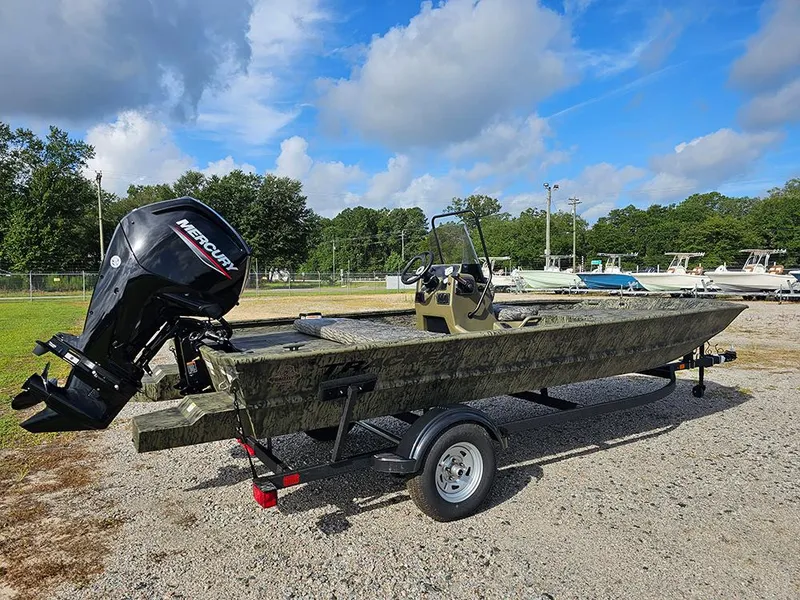 Slide: The Image of 2026 Tracker Grizzly 1860 CC boat with Mercury engine on trailer, outdoors. - 3