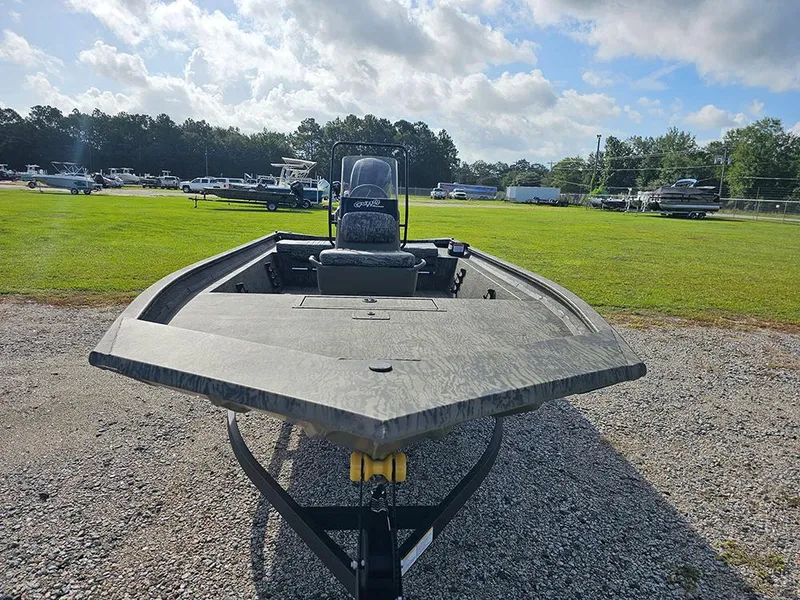 Slide: The Image of 2026 Tracker Grizzly 1860 CC boat on trailer, parked on gravel with grassy background. - 4