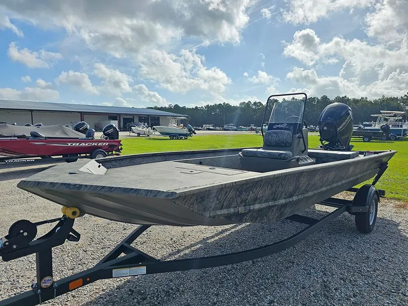 Slide: The Image of 2026 Tracker Grizzly 1860 CC boat on trailer under a partly cloudy sky. - 5