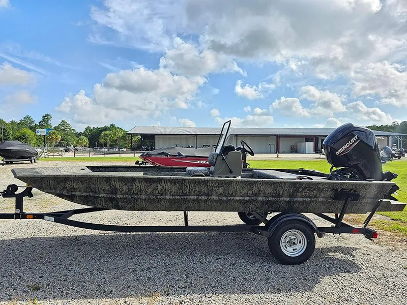 Slide: The Image of 2026 Tracker Grizzly 1860 CC boat on trailer, outdoors under blue sky. - 6