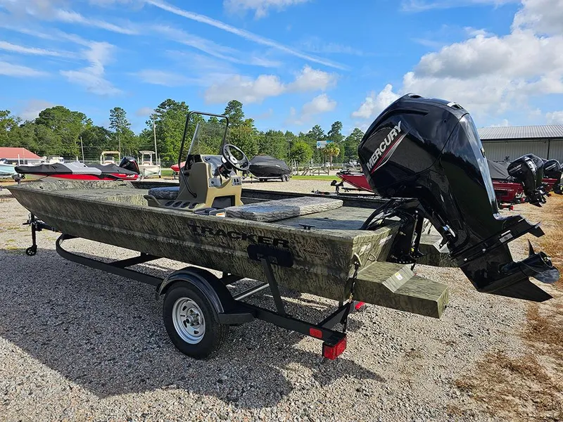 Slide: The Image of 2026 Tracker Grizzly 1860 CC boat with Mercury engine on trailer, outdoors. - 7