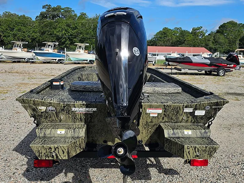 Slide: The Image of 2026 Tracker Grizzly 1860 CC boat with camo design and powerful outboard motor. - 8