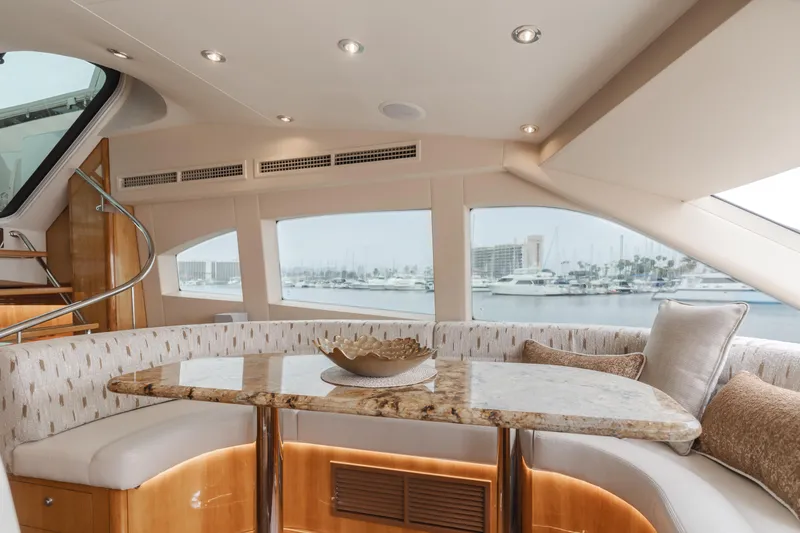 Slide: The Image of Luxurious interior of 2007 Hatteras 64 Motor Yacht with elegant seating and marina view. - 11