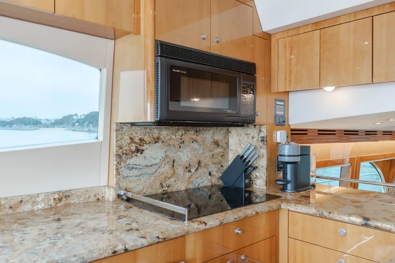 Slide: The Image of Luxurious kitchen interior of 2007 Hatteras 64 Motor Yacht with modern appliances and granite countertops. - 14