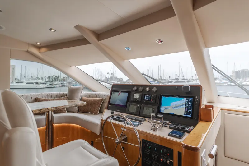 Slide: The Image of 2007 Hatteras 64 Motor Yacht helm with navigation screens and luxurious seating. - 15