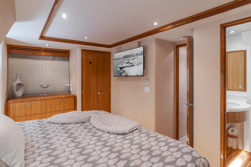 Slide: The Image of Luxurious bedroom interior of 2007 Hatteras 64 Motor Yacht with modern decor and ensuite bathroom. - 18