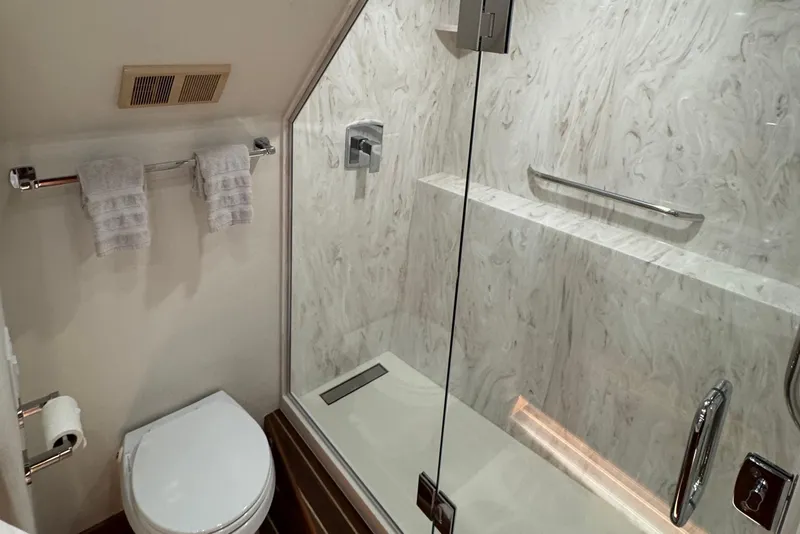 Slide: The Image of Luxurious bathroom in 2007 Hatteras 64 Motor Yacht with glass shower and modern fixtures. - 23