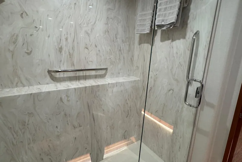 Slide: The Image of Luxurious shower in 2007 Hatteras 64 Motor Yacht with marble walls and glass door. - 24
