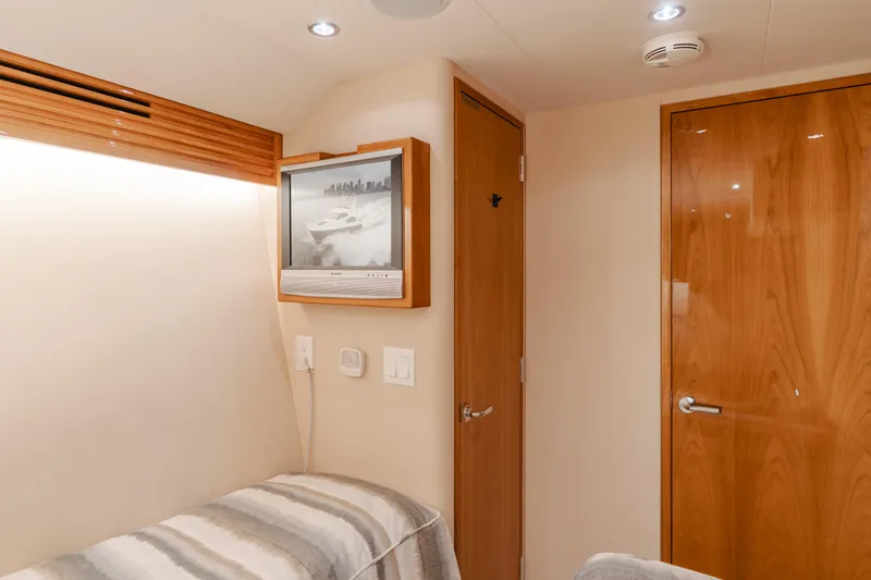 Slide: The Image of Interior of 2007 Hatteras 64 Motor Yacht with TV and wooden doors. - 29