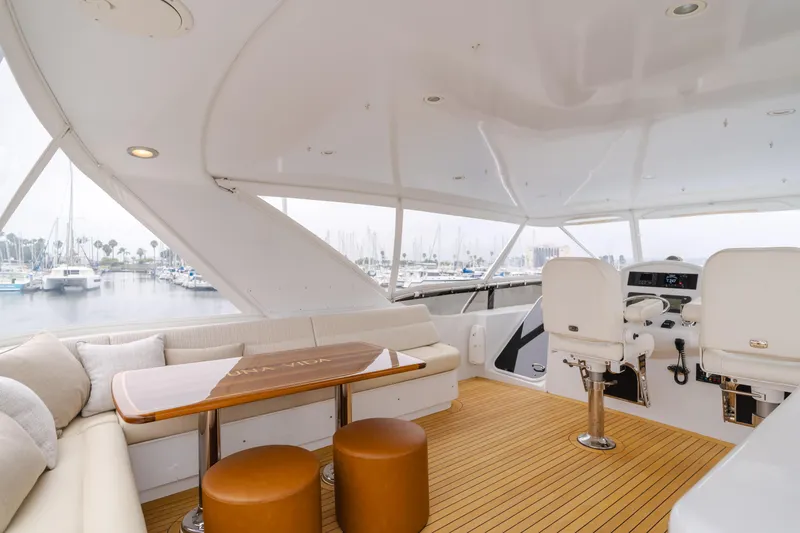 Slide: The Image of Luxurious 2007 Hatteras 64 Motor Yacht interior with seating and helm, docked at marina. - 32