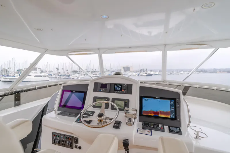 Slide: The Image of Helm of 2007 Hatteras 64 Motor Yacht with advanced navigation systems, overlooking marina. - 33