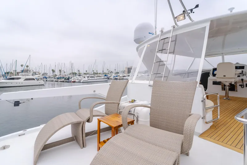 Slide: The Image of 2007 Hatteras 64 Motor Yacht deck with lounge chairs, marina view. - 37
