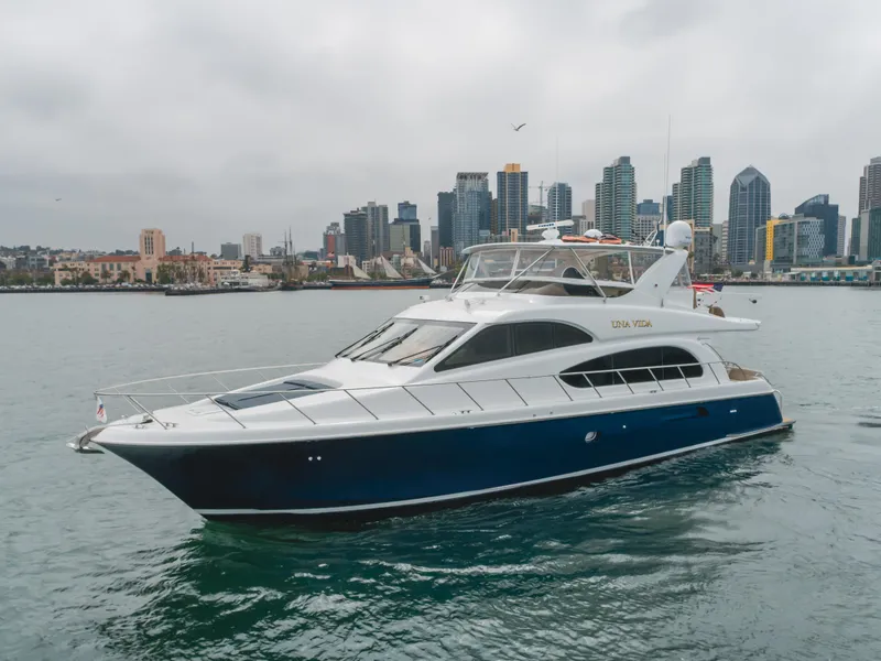 Slide: The Image of 2007 Hatteras 64 Motor Yacht cruising near city skyline on a cloudy day. - 4