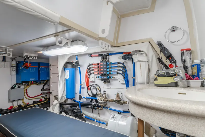 Slide: The Image of Engine room of 2007 Hatteras 64 Motor Yacht with water filtration system and electrical components. - 43
