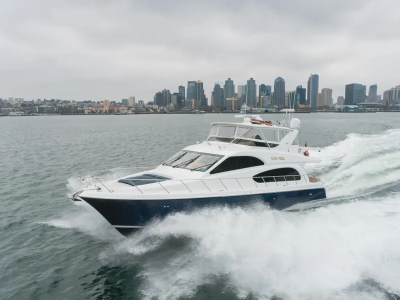 Slide: The Image of 2007 Hatteras 64 Motor Yacht cruising near city skyline on a cloudy day. - 5