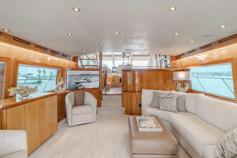 Slide: The Image of Luxurious interior of a 2007 Hatteras 64 Motor Yacht with elegant furnishings and large windows. - 7