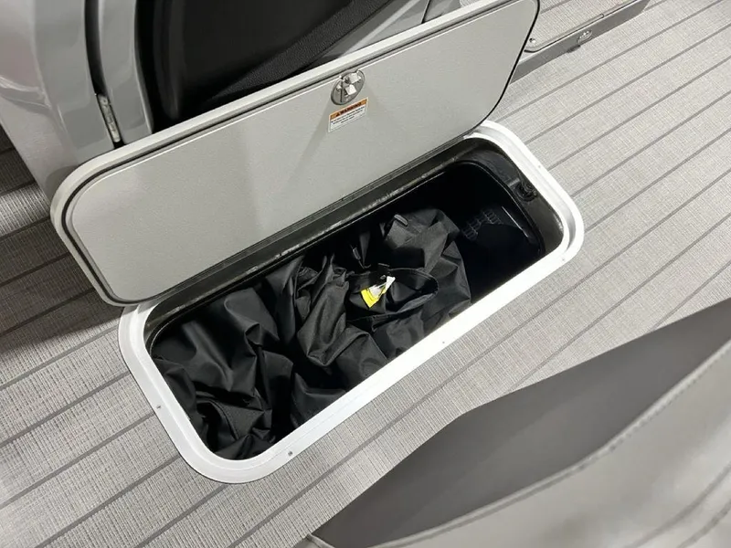 Slide: The Image of Storage compartment on 2025 Godfrey AquaPatio 235 SFLC boat, featuring sleek design and practical utility. - 10