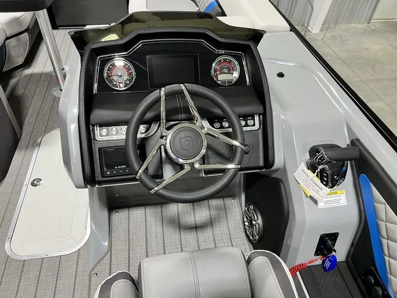 Slide: The Image of 2025 Godfrey AquaPatio 235 SFLC iMPACT helm with modern controls and sleek steering wheel. - 16