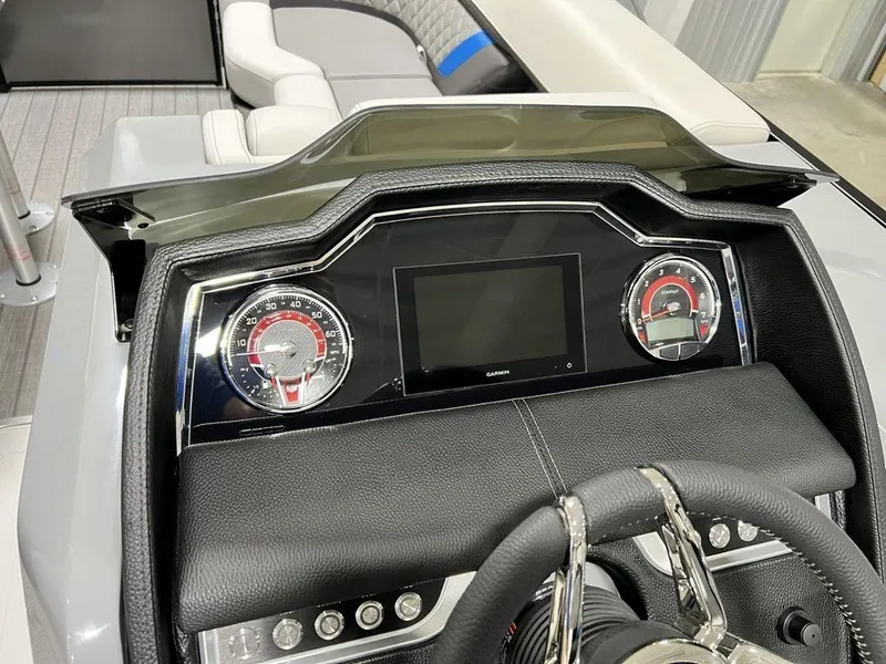 Slide: The Image of Dashboard of 2025 Godfrey AquaPatio 235 SFLC iMPACT boat with modern controls and steering wheel. - 17