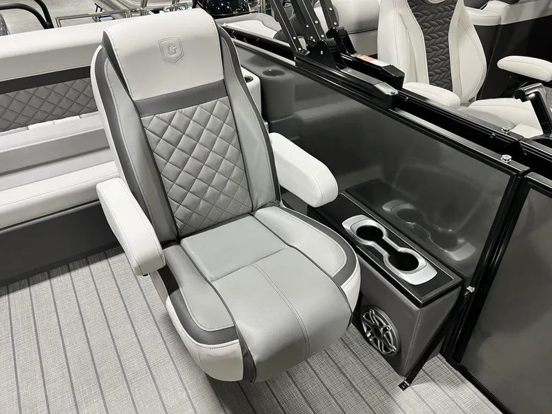 Slide: The Image of Luxurious seating on 2025 Godfrey AquaPatio 235 SFLC boat, featuring quilted design and cup holders. - 18