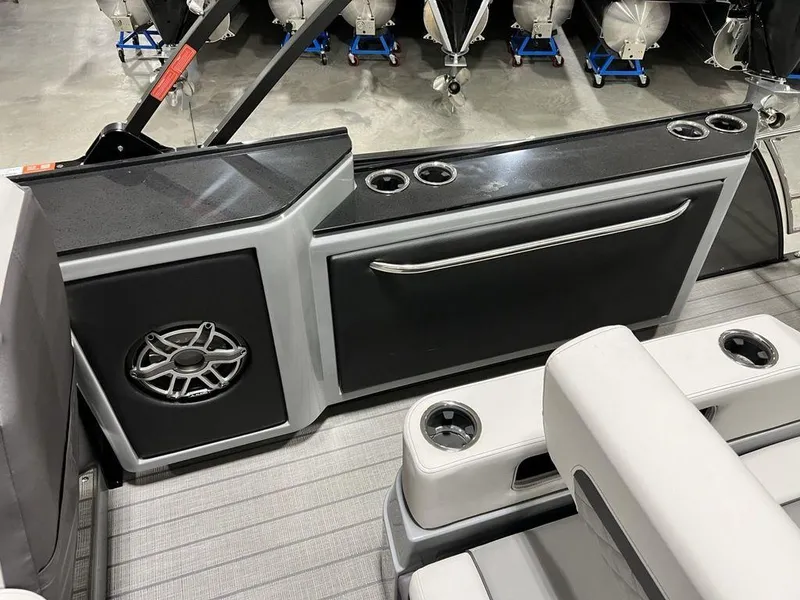 Slide: The Image of 2025 Godfrey AquaPatio 235 SFLC boat interior with speaker and cup holders. - 20