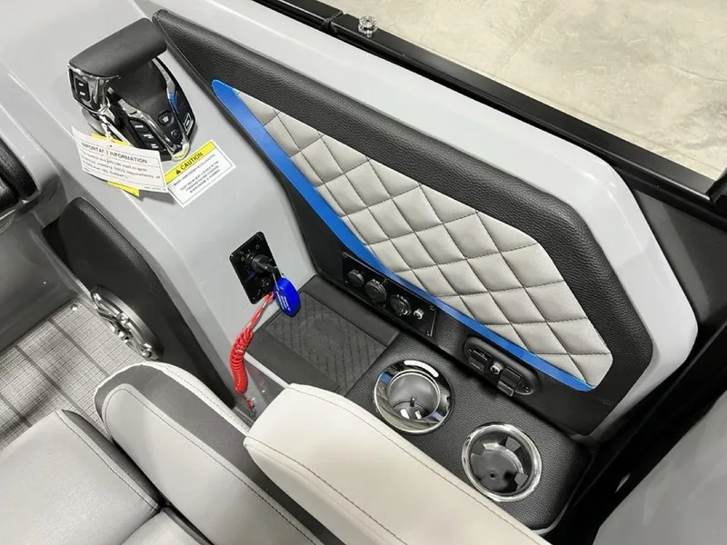 Slide: The Image of Interior of 2025 Godfrey AquaPatio 235 SFLC, featuring control panel and cup holders. - 22