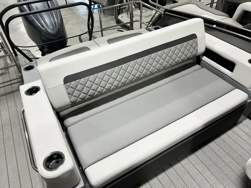 Slide: The Image of 2025 Godfrey AquaPatio 235 SFLC boat interior with quilted seating and cup holders. - 24