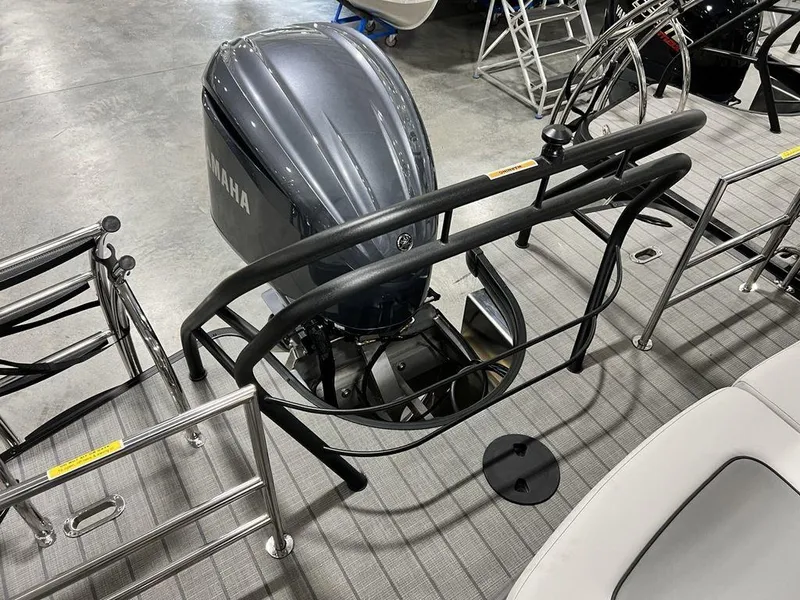 Slide: The Image of 2025 Godfrey AquaPatio 235 SFLC boat with Yamaha outboard motor, docked indoors. - 27