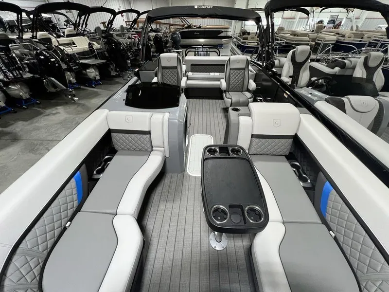 Slide: The Image of Luxurious 2025 Godfrey AquaPatio 235 SFLC pontoon boat interior with elegant seating and table. - 29