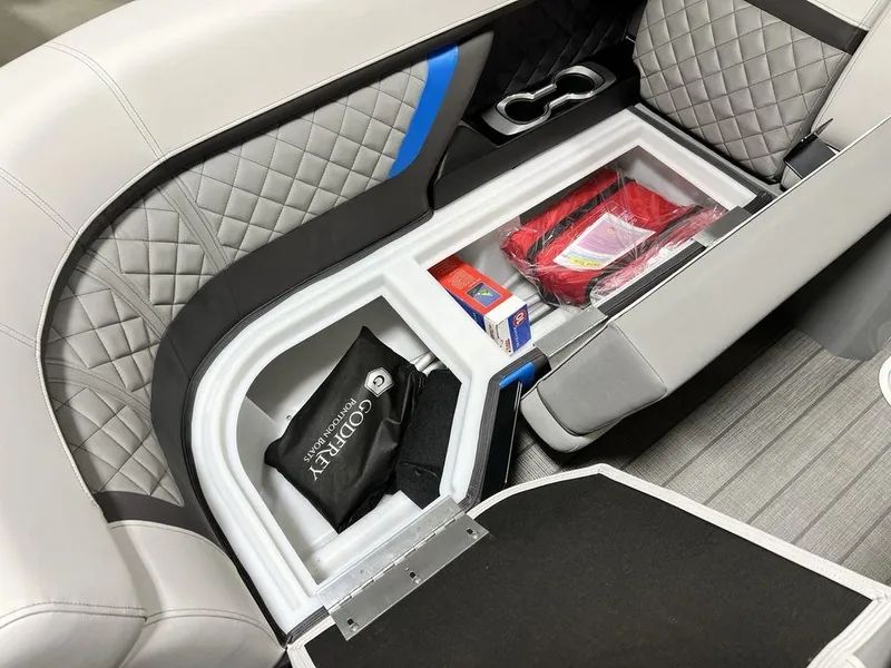 Slide: The Image of Interior storage of 2025 Godfrey AquaPatio 235 SFLC boat with quilted seats and accessories. - 3