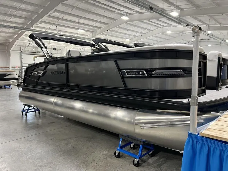 Slide: The Image of 2025 Godfrey AquaPatio 235 SFLC iMPACT pontoon boat in showroom, side view. - 4
