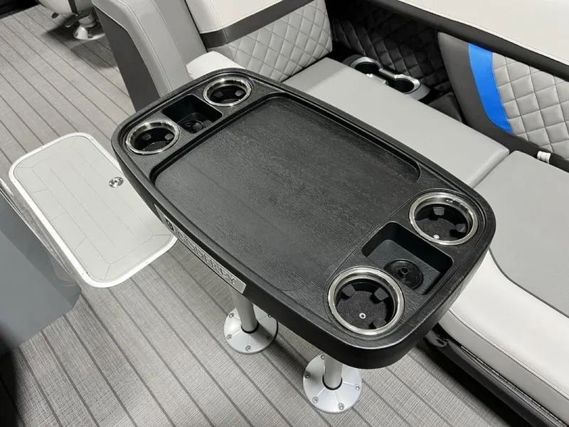 Slide: The Image of Luxury seating and table setup on 2025 Godfrey AquaPatio 235 SFLC boat, featuring cup holders. - 5